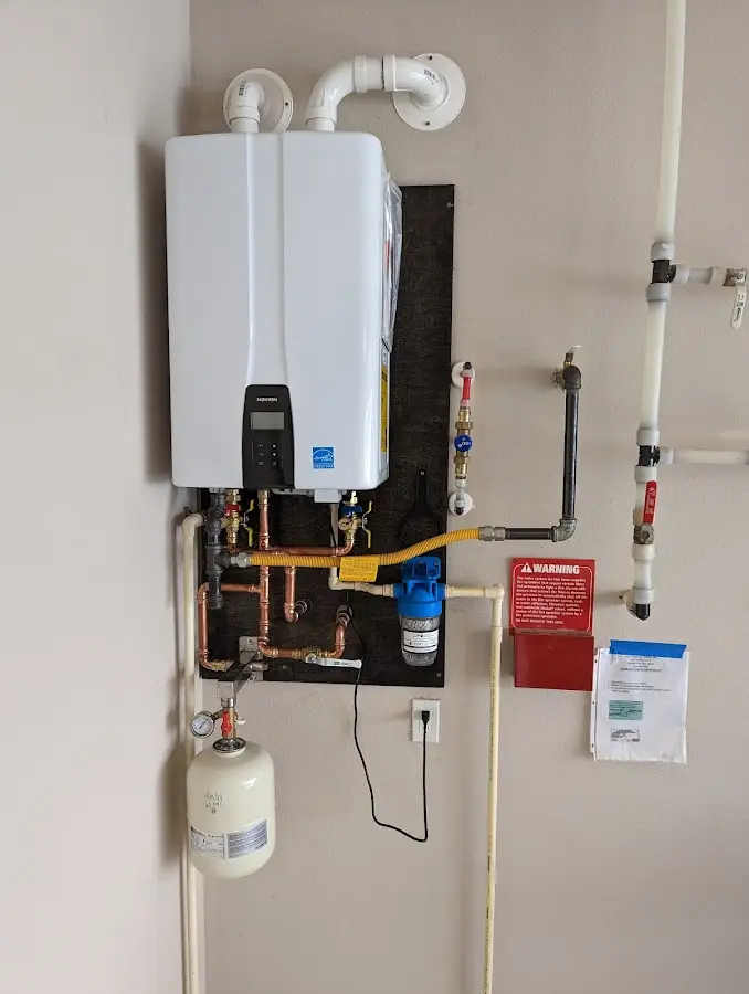 Professional plumber installing copper piping in a Lake Goodwin home